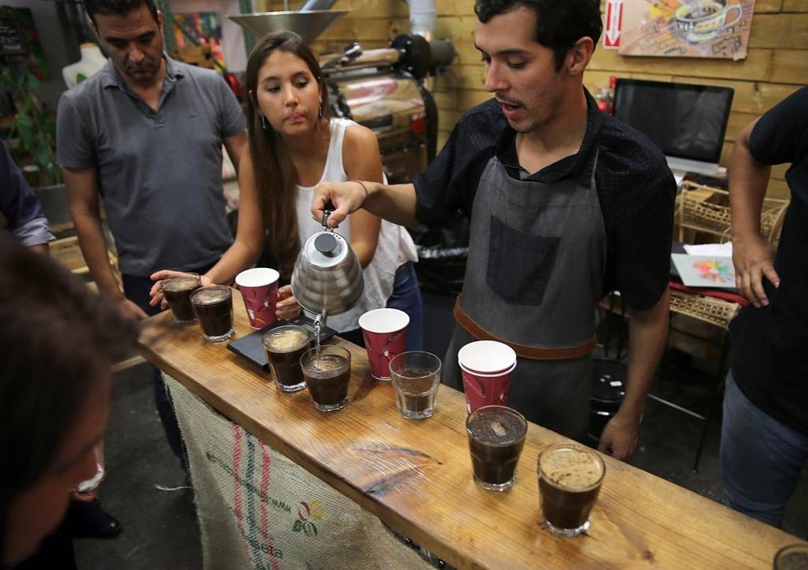 Coffee expert Saul Zuaza serves different kinds of coffee with different roasting processes for attendees to taste during a coffee class at Macondo Coffee in Doral.