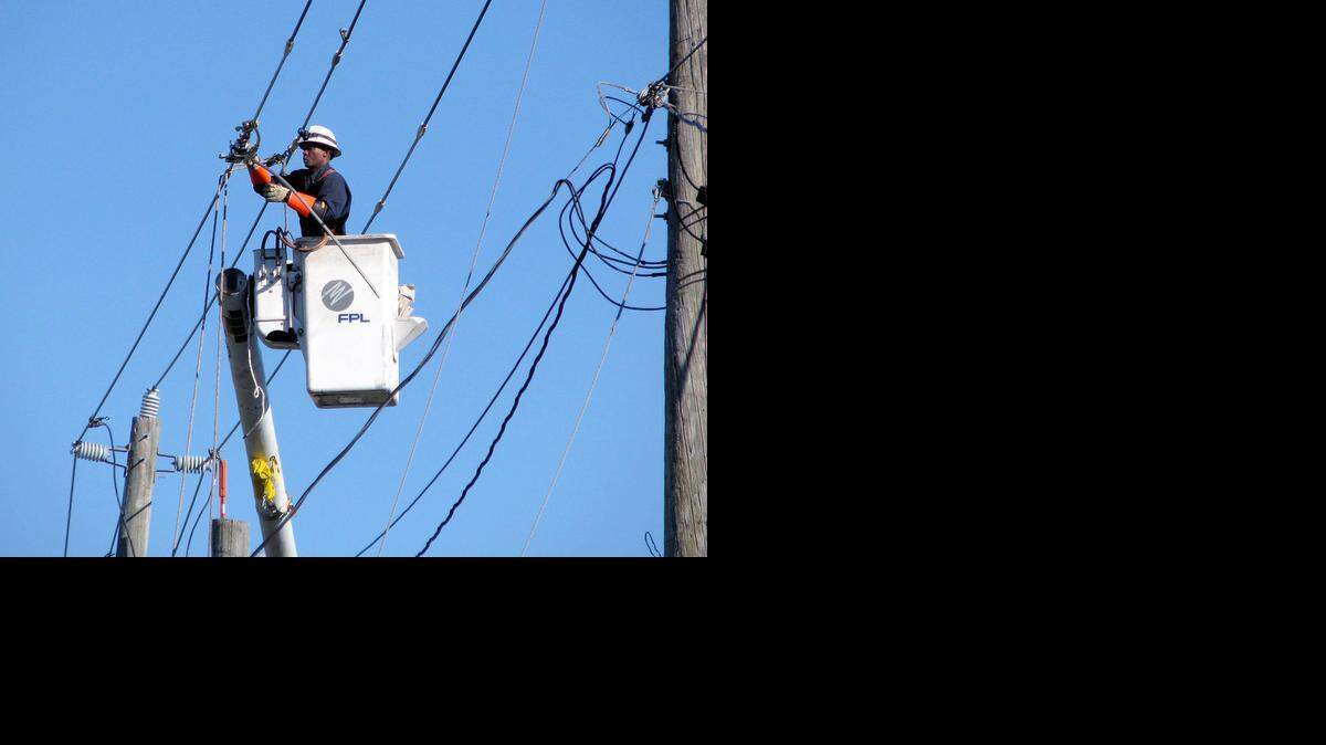 
An FPL technician works on a repair in Hialeah this week. 
