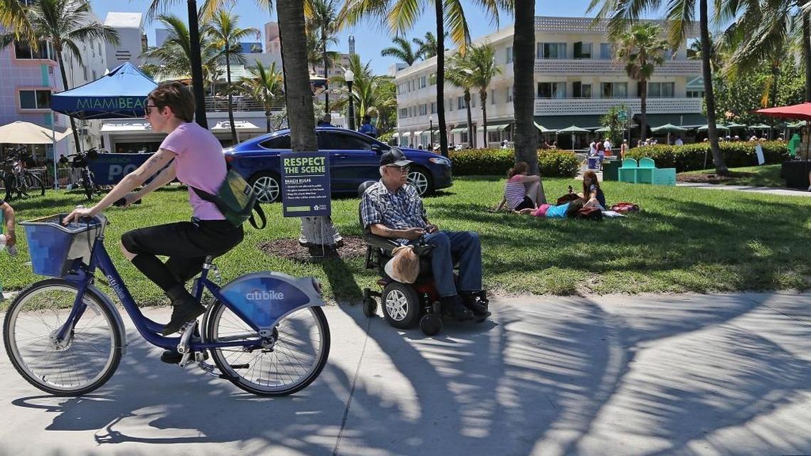 Miami Beach resident David Marrero, 71, center, welcomes the police presence during Memorial Day weekend 2016, he said. Arrests were down by more than half last year compared to 2013.