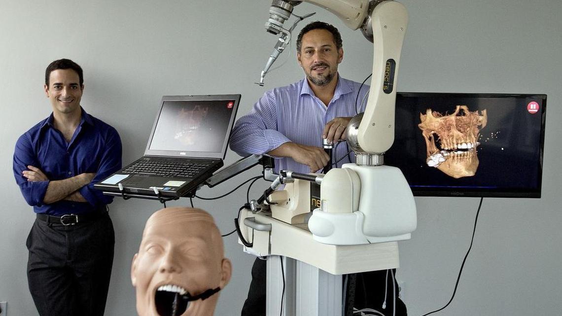 Alon Mozes, left, and Juan Salcedo started the healthcare robotics company Neocis. The team is creating a robotic guidance system for the fast-growing dental implant market.