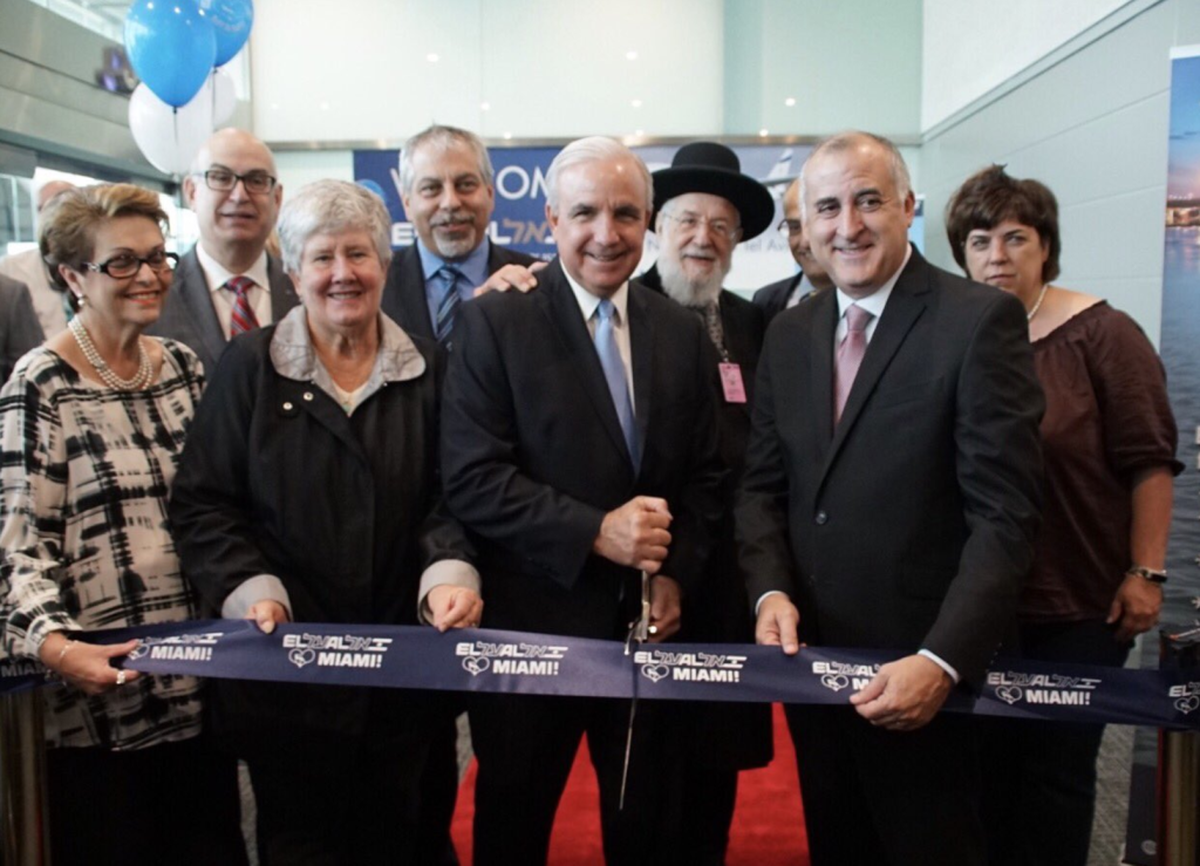 Miami-Dade County Commissioners Rebeca Sosa and Sally Heyman, Miami-Dade Mayor Carlos Gimenez, and county commissioner Esteban Bovo, cut the ribbon at the launch of El Al flights at Miami International Airport on Wednesday, November 1.