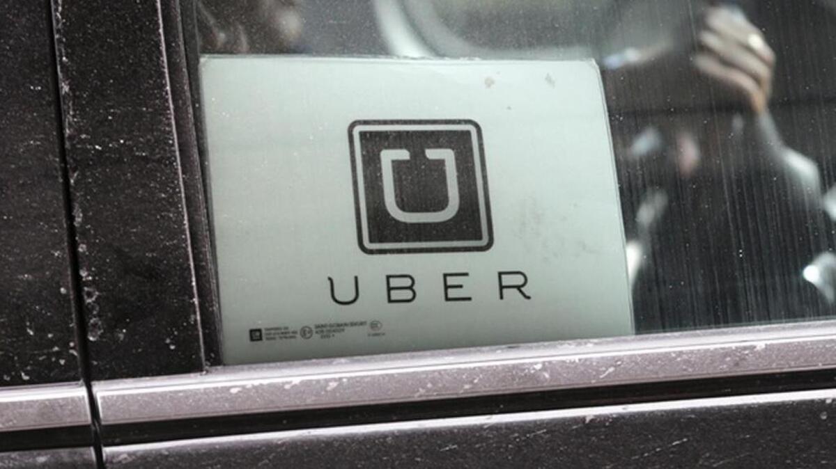 An Uber car drives through LaGuardia Airport in New York. Uber is enabling passengers to tip its U.S. drivers with a tap on its ride-hailing app for the first time. (AP Photo/Seth Wenig, File)