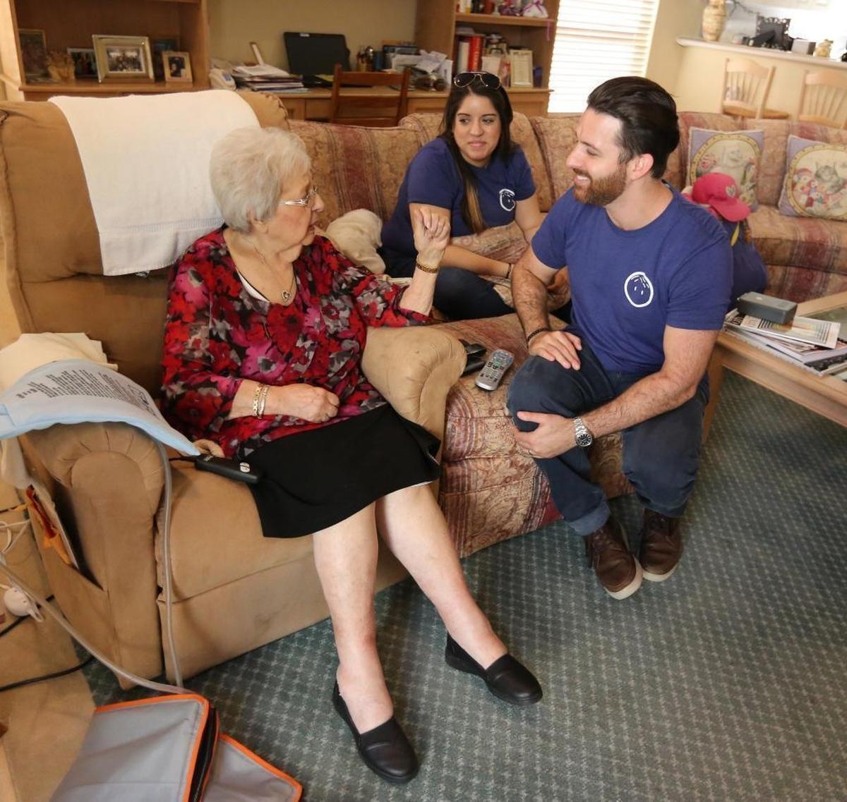 Olga DeMartino, 92, visits with Papa founder Andrew Parker and Papa employee, Valeria Sosa, 26, Nov. 14, 2017, in her Coral Springs home. Parker runs a startup called Papa. It provides “grandkids on demand” — basically college students hired to help elderly customers by taking them to hair appointments or to get groceries, or to do a little cleanup or cooking, or just to be a companion.
