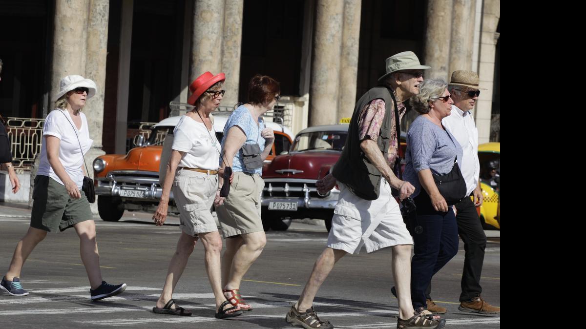 
In this March 13, 2015 file photo, tourists cross a street in Havana, where lodging business Airbnb reports it has doubled its listings.
