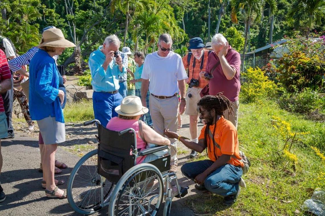 Tourists are greeted by local guides in Dominica. The island has reopened its airport and cruise port.