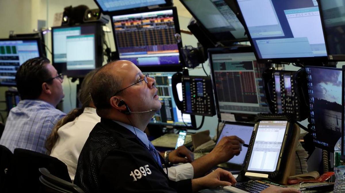 
Trader Jeffrey Vazquez works in a booth on the floor of the New York Stock Exchange, Thursday, Aug. 20, 2015. 
