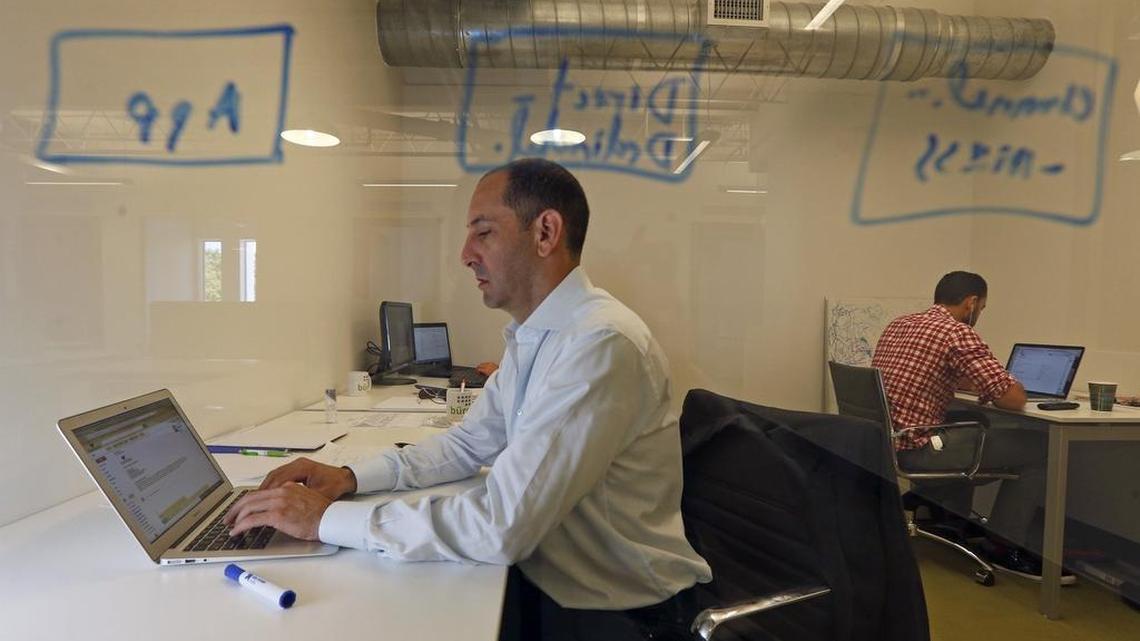 Young renters and buyers want modern amenities, such as a coworking space within a high-rise or a partnership with a local, nearby coworking facility. Above: Marc Billings and Tito Gaudenzi, with art-tech startup Blackdove, work at Buro MiMo in 2015 in northeast Miami.