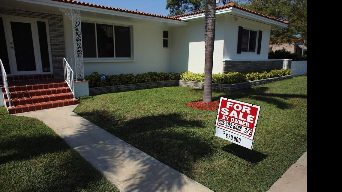 
A “for sale” sign stands in front of a home in Miami in 2013.
