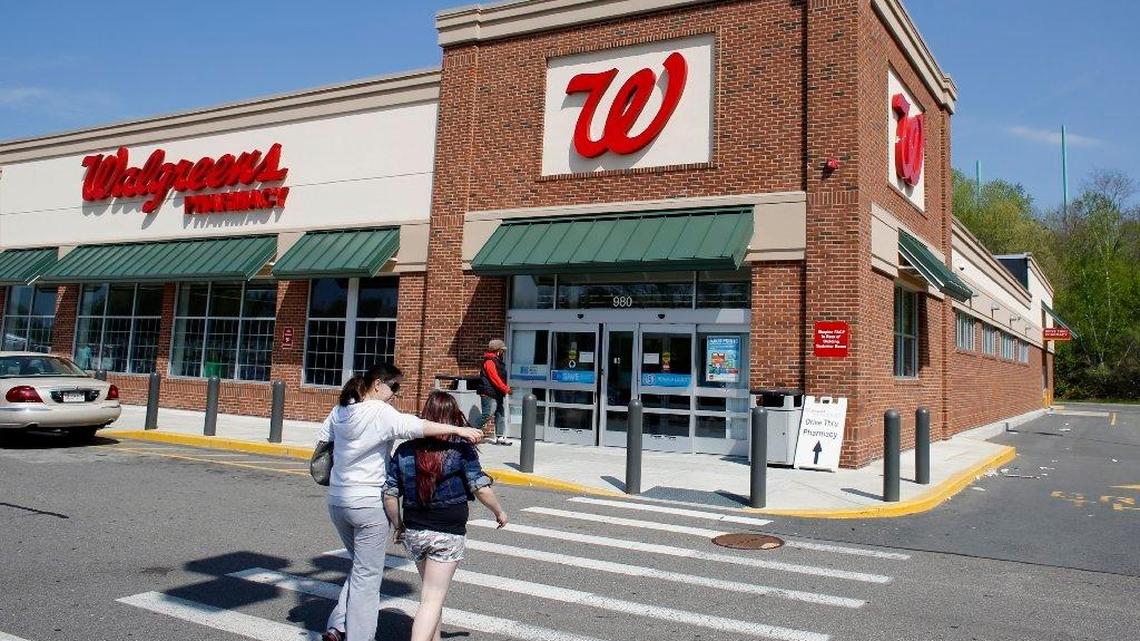 Customers walk toward a Walgreens store in Boston in 2014.