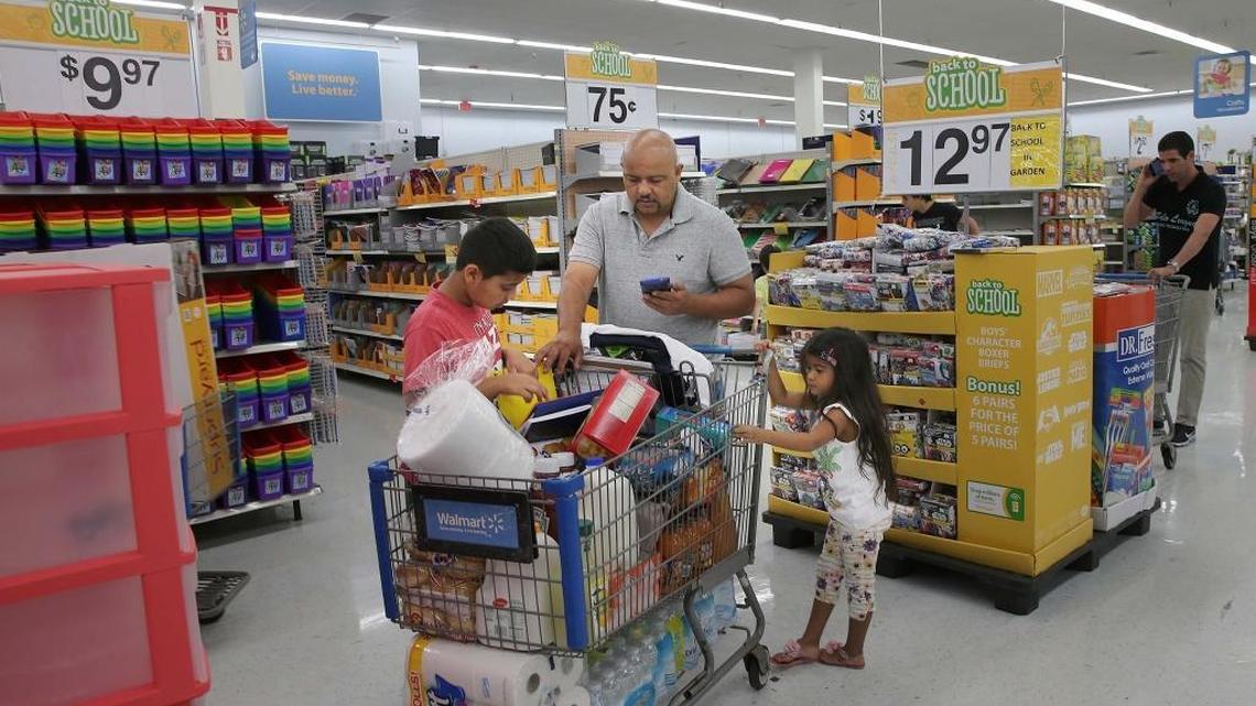Melvin Trochez, with daughter Mia, checks items for his son Bryan's schools supplies shopping list at the back-to-school store section at the Walmart Doral SuperCenter on Aug. 2, as the store prepares for the tax-free holiday. The tax-free holiday is three days this year, from Aug. 5 to Aug. 7, much shorter than years past. Last year the holiday lasted 10 days.