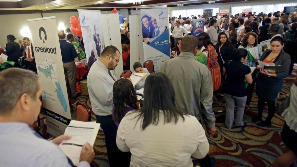Job seekers checking out companies at a job fair in Miami Lakes in August 2013.