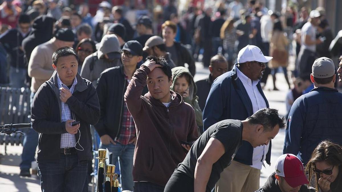 Prospective Tesla Model 3 owners wait in line to place a deposit on the new electric car model expected to go into production next year, in Santa Monica, Calif., on Thursday, March 31, 2016.