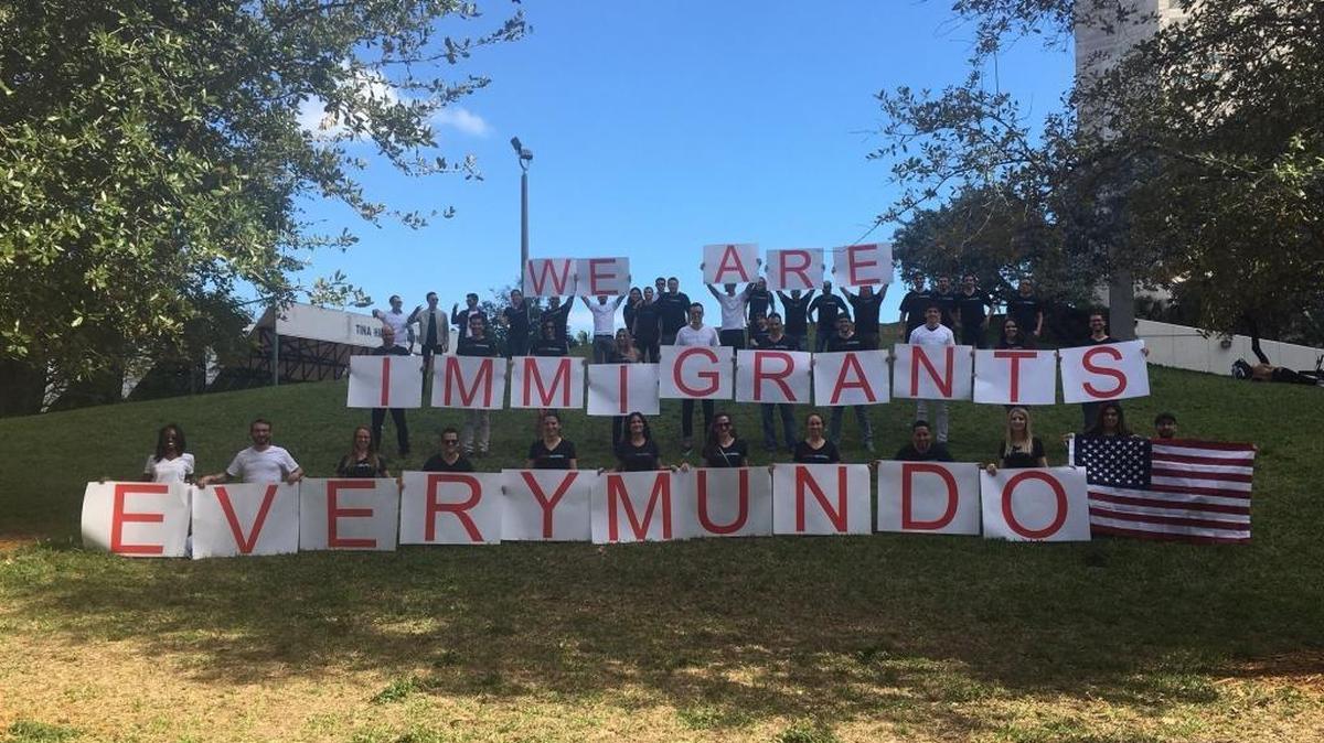 Team members of EveryMundo, a Miami technology company, display their message in Bayfront Park near their offices in downtown Miami. The marketing technology company serving the travel and hospitality industry has about 57 full-time employees in Miami and 37 of them were born outside the United States, said CEO Anton Diego.