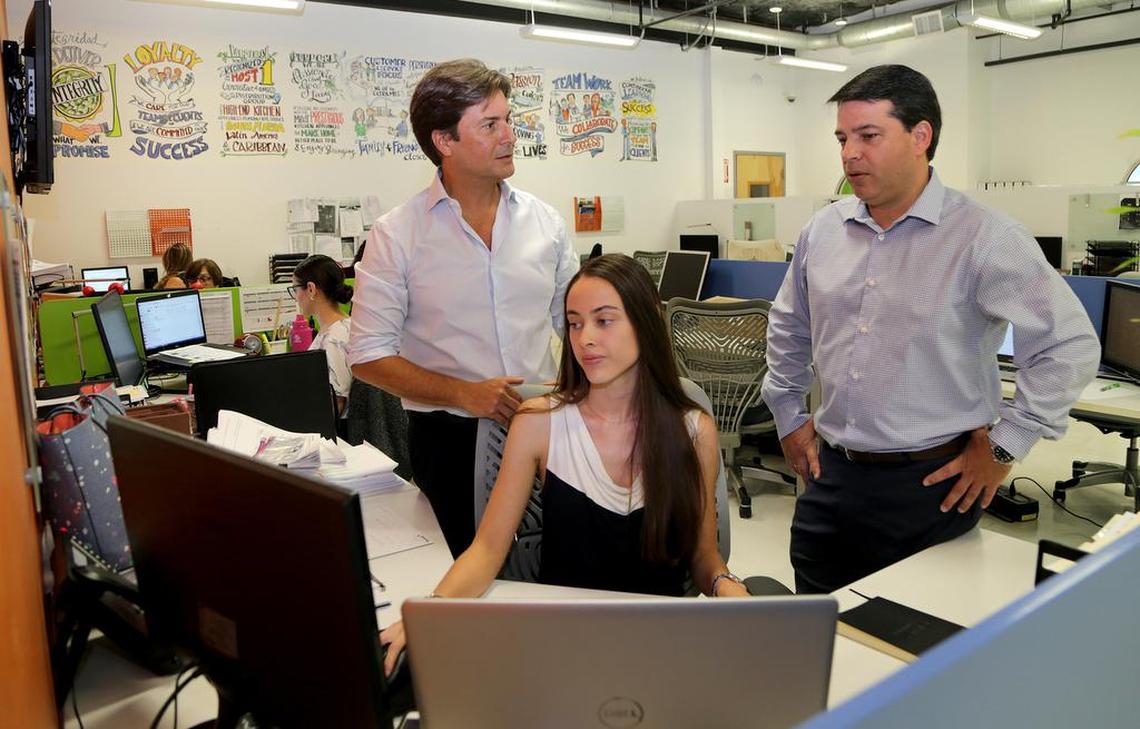 Josu Gaubeka and Rafael Guerrero discuss business with financial analyst Manuela Rodriguez, in La Cuisine International’s office in Doral.