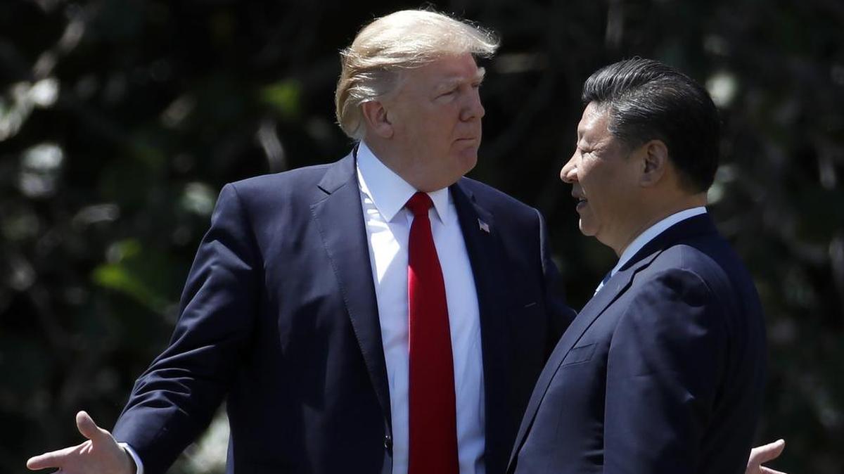 In this April 7, 2017, file photo, U.S. President Donald Trump gestures as he and Chinese President Xi Jinping walk together after their meetings at Mar-a-Lago, in Palm Beach. “Successful and sustainable trade deals need to be founded upon solid economic principles, but they also need to be politically tolerable. Investors are growing more concerned the U.S.-China trade discussions increasingly are neither as another round of talks is scheduled in the week ahead.”