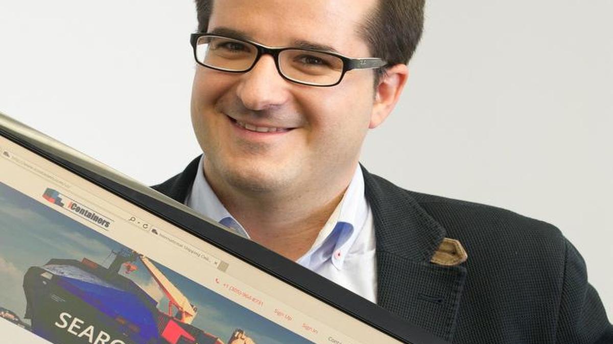 
Carlos Hernández, co-founder and global managing director of iContainers, holds up a monitor displaying the company website inside the U.S. headquarters in Miami on June 25, 2015.
