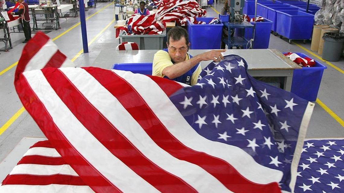 Jorge Proenza, 52, feels for imperfections as he flips a large U.S. flag at the Goodwill of South Florida’s Flag Center in Miami. Proenza, who is blind, is one of about 60 employees at the Goodwill operation that produces about 85,000 interment flags annually for the U.S. Department of Veterans Affairs.