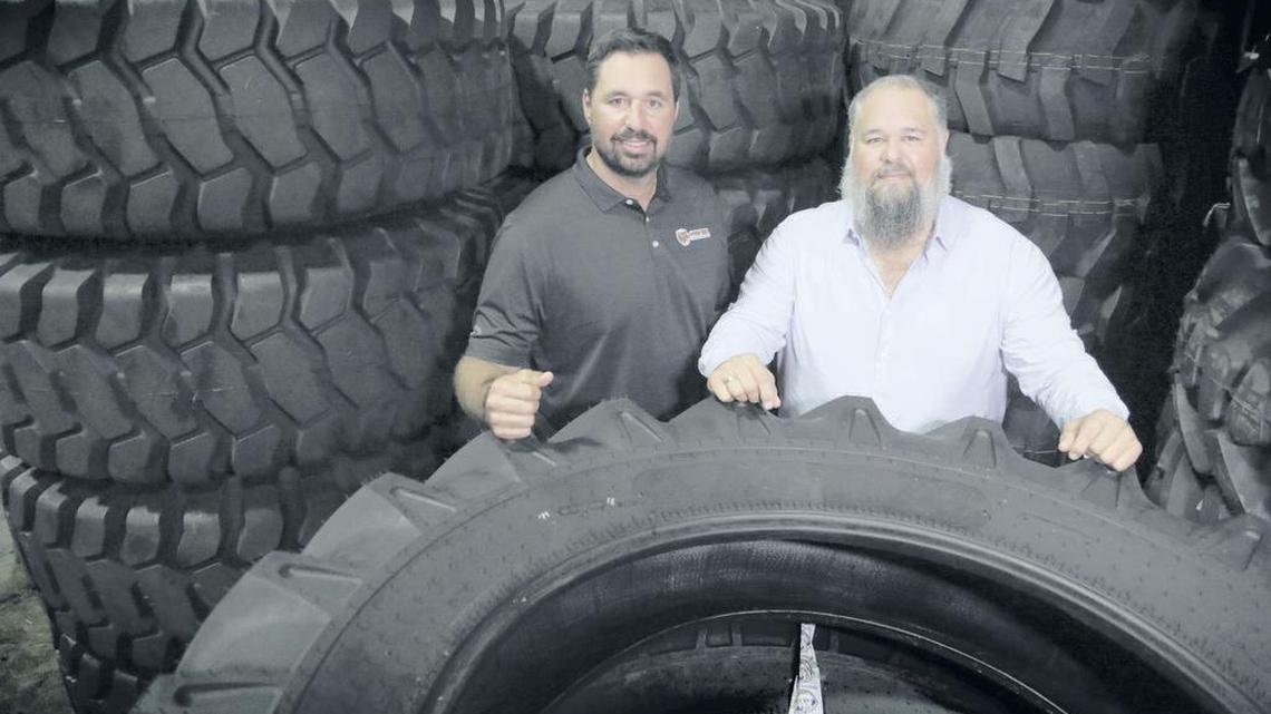 Joaquin Gonzalez, left, who is president, and Antonio “Tony” Gonzalez, CEO of Tire Group International inside the warehouse facility.