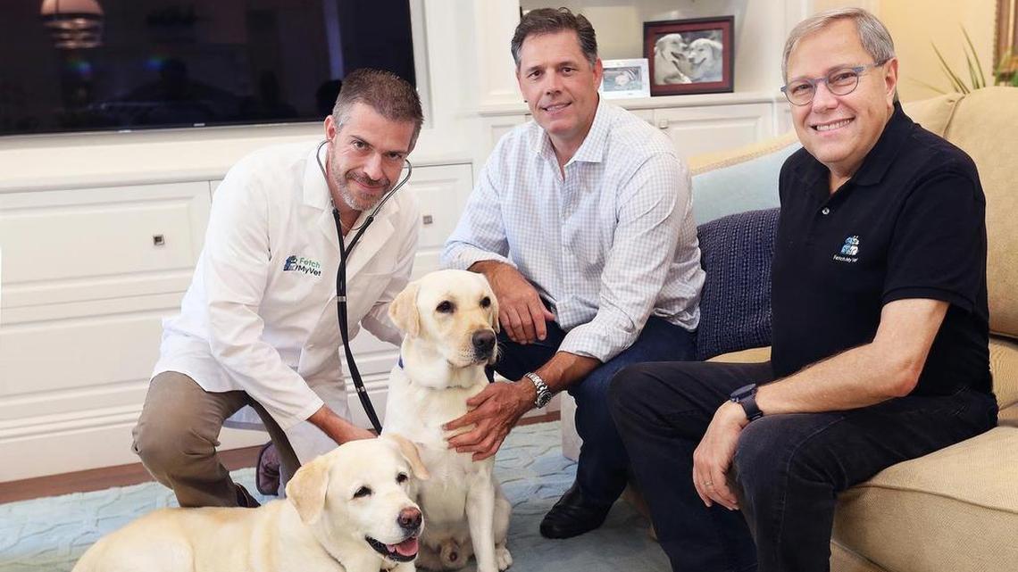 Dr. Michael Sanwald, left, with business partners Bert Weidner, middle, and Barry Katz — the founders of Fetch My Vet — with Buddy and Gus, yellow Labrador retrievers, at a home in Fort Lauderdale.