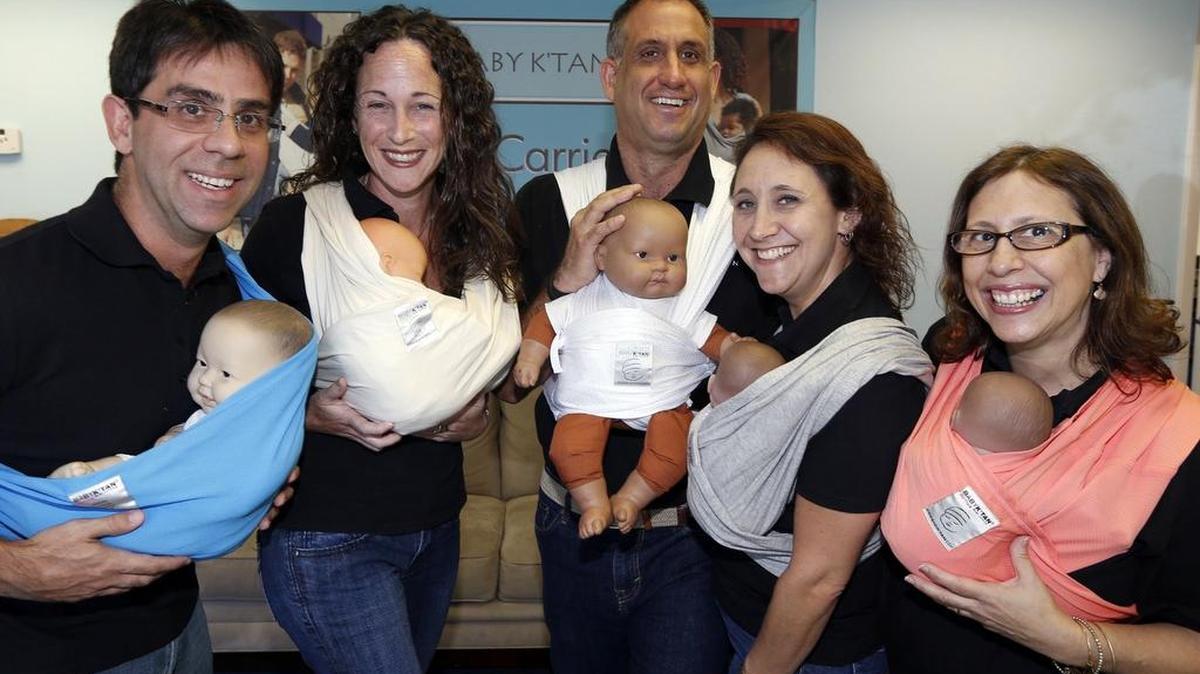 
From left: Robert Rincón, Michal Chesal, Isaac Wernick, Abby Schochet and Jamie Cohn, with dolls wrapped in Baby K’tan carriers. 
