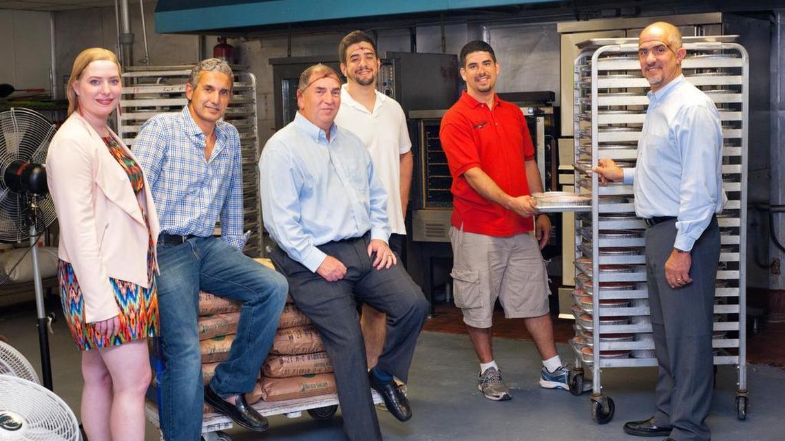 From left, SCORE volunteers Jane Muir, Rafael Iglesias and Doug Shavel, with Erick Irsula, Milo Irsula and Orlando Irsula, owner of family-run Cheesecake, Etc. in Miami Springs.