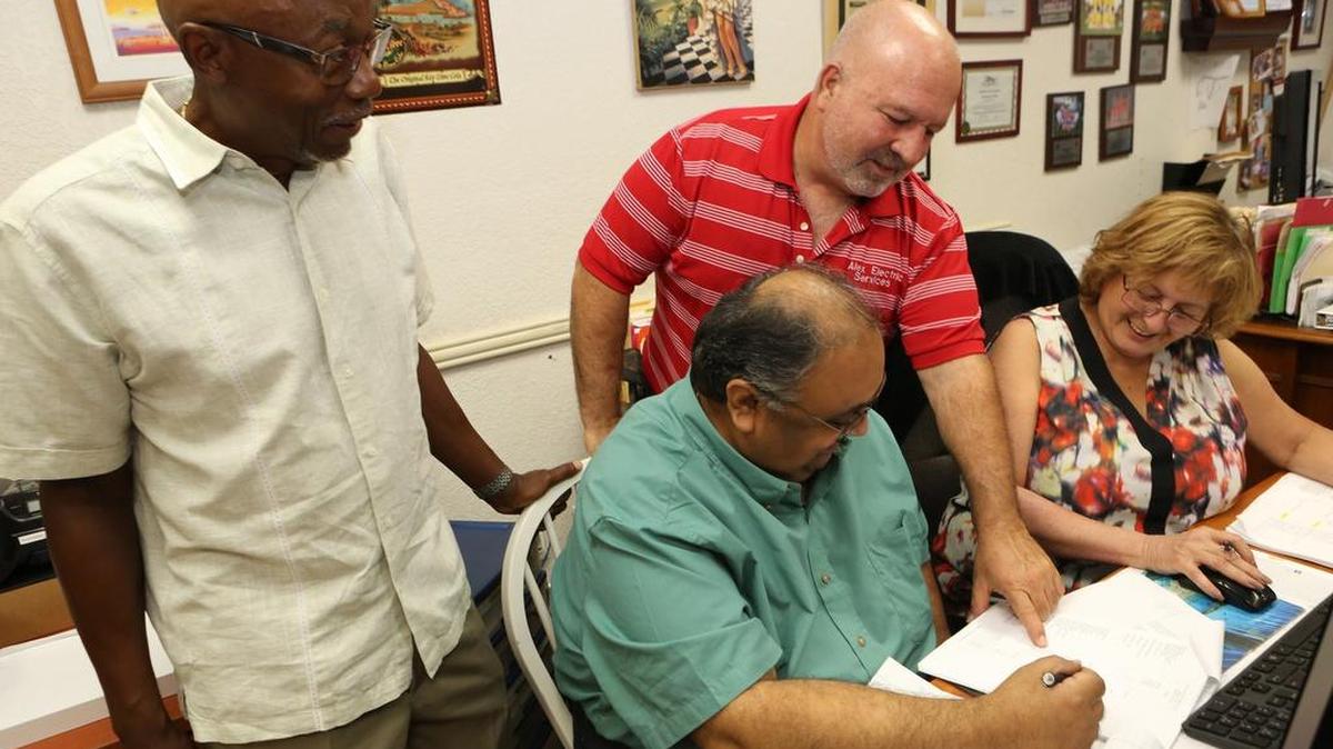 From left: Alvin Hayes from SCORE Miami-Dade, Raju Mohandas from SCORE Miami-Dade (seated), Alex Varela, and Nikki Howard, bookeeper of Alex Electric in Hialeah.