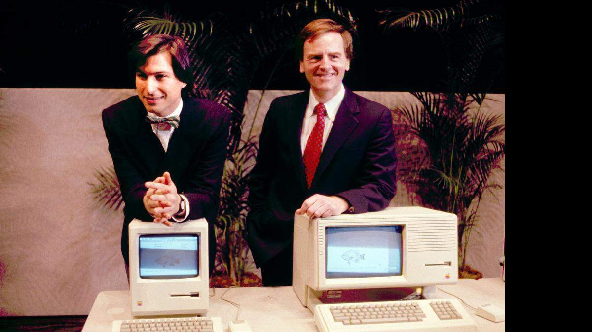
This January 1984, file photo, shows Apple CEO Steven P. Jobs, left and President John Sculley presenting the new Macintosh Desktop Computer in January 1984 at a shareholder meeting in Cupertino, Calif. 
