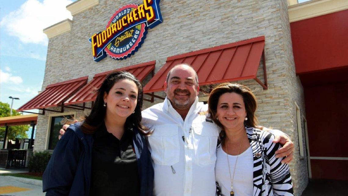 Marcelo Montalvan, center, and wife Berny Montalvan, right, are the owners, and Andrea Montalvan, left, is the marketing director, of Fuddruckers. The company is being liquidated but five South Florida locations will be unaffected — and a sixth is opening this year.