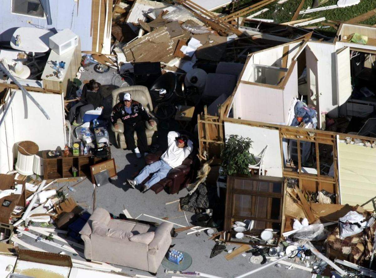 Two men sit in a destroyed mobile home in Fort Lauderdale on Oct. 25, 2005 after Hurricane Wilma slammed the state. Many of the smaller insurers in Florida at the time went under after the severe 2004-05 storm season.