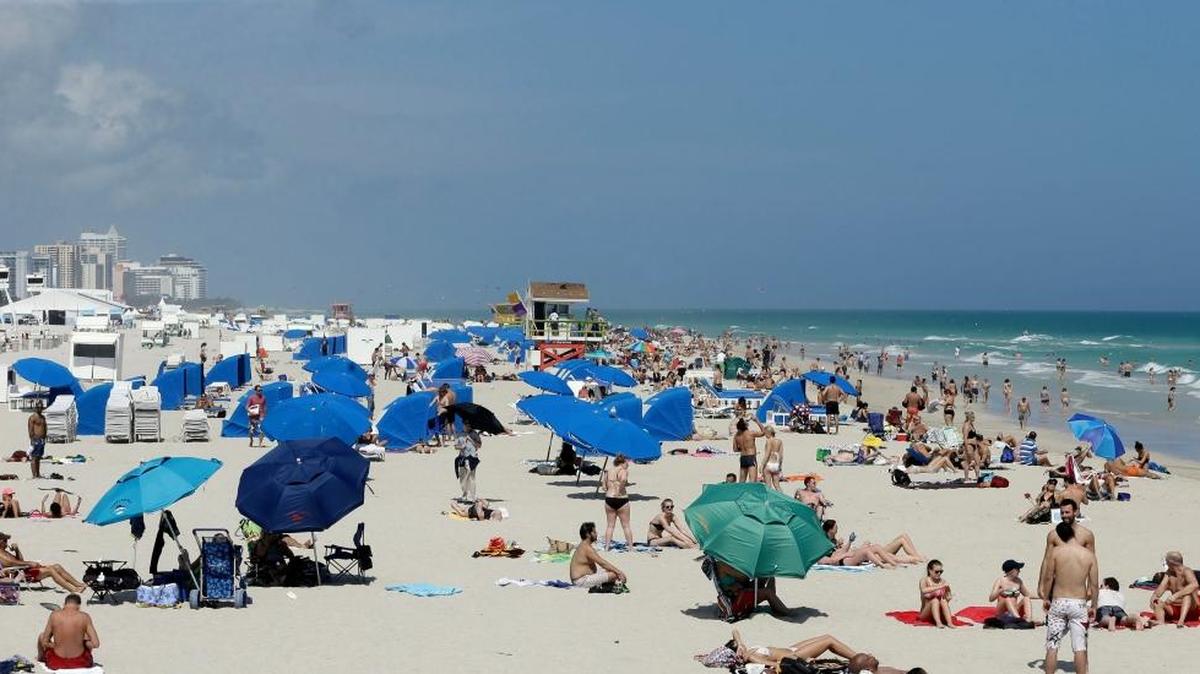 Tourists and local residents enjoy a day at the beach on Feb. 2 in the South Beach area of Miami Beach.