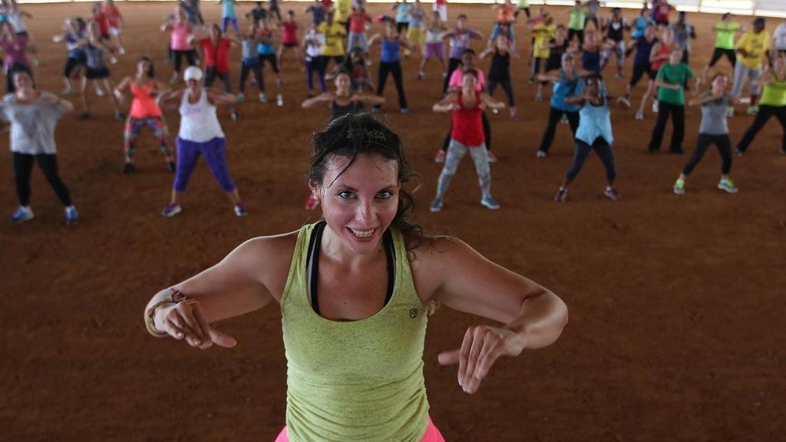 Michelle Donoso, center front, works out with Zumba clubs, and residents of all ages and skill levels, who came out to the Tropical Park Equestrian Complex for a Zumba dance party last year.