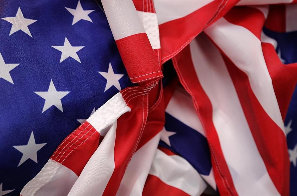 A pile of nylon American flags are gathered to be stitched on Monday, June 19, 2017 inside the Freedom Flag & Banner Company in North Miami.