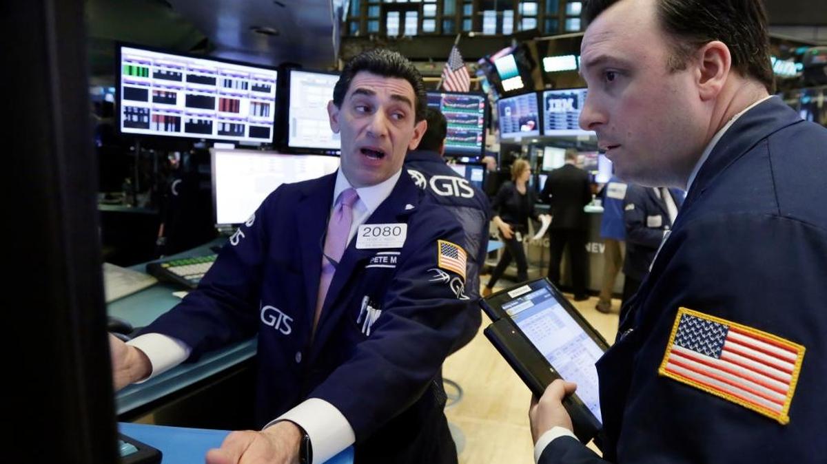 Specialist Peter Mazza, left, and trader Brandon Barb work on the floor of the New York Stock Exchange on Tuesday. The stock market hasn’t been this optimistic about profits on the eve of a quarterly earnings season since the summer of 2004.