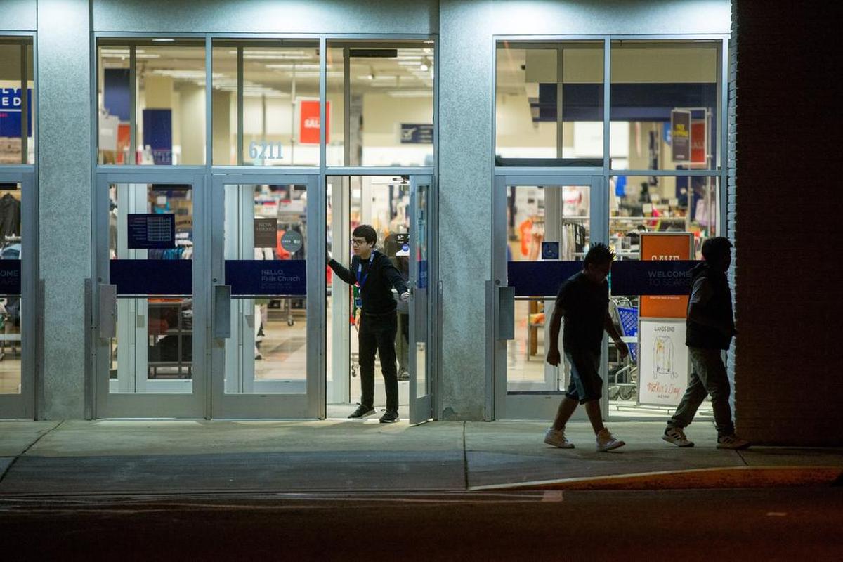 An employee prepares to lock up for the night at the Sears on Leesburg Pike in Falls Church, Virginia.