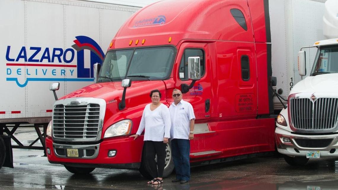 Marlene Perez and husband Lazaro Ramos, co-owners of Lazaro Delivery, with some of their tractors at the company headquarters.