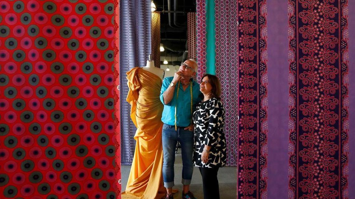 Scholar-in-residence Nicholas Huxley with Miami Dade College’s Director of Academic Program Development Marimar Molinary at the Miami Fashion Institute amid a sea of colorful fabrics.