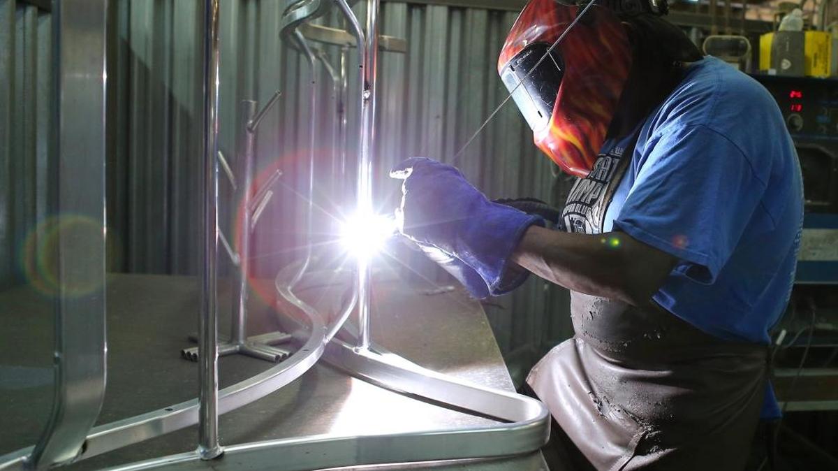 Kenny Francis, welder at Pavilion Furniture, shapes the frame of a piece of furniture on Oct. 13.