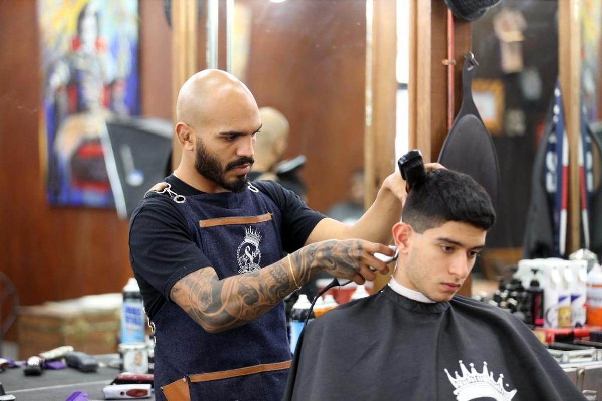 Dion Rivera cuts Pablo Espat’s hair at The Spot Barbershop in Coral Gables.