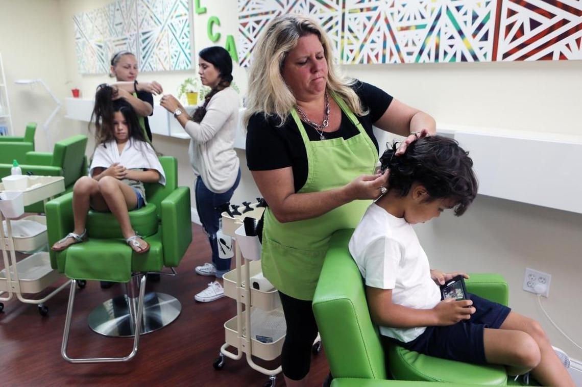 Lice Clinics of America Miami is “urgent care for lice.” From left, at back: Patricia Perez, 8, and Maryna Torrealba-Grinen, lead technician at Lice Clinic of America Miami, with Sandra Perez. In foreground: Heather Wilson O'Connor and Edward Perez, 6.