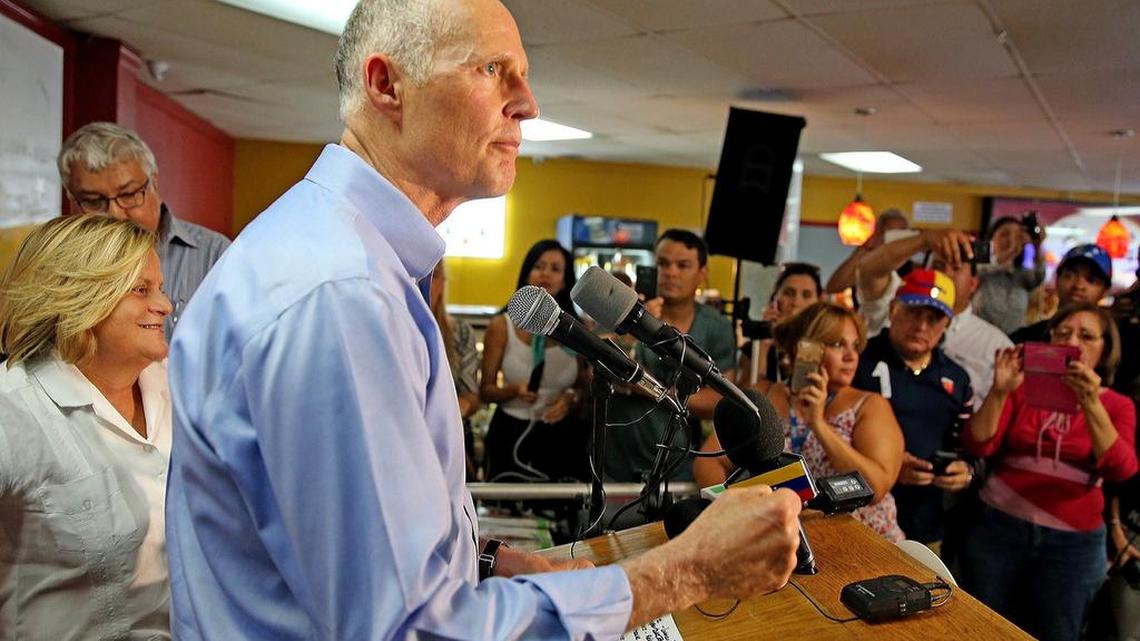 Gov. Rick Scott speaks at El Arepazo restaurant in Doral on July 10; Rep. Ileana Ros-Lehtinen is also shown. Scott has announced sanctions against the Maduro regime.