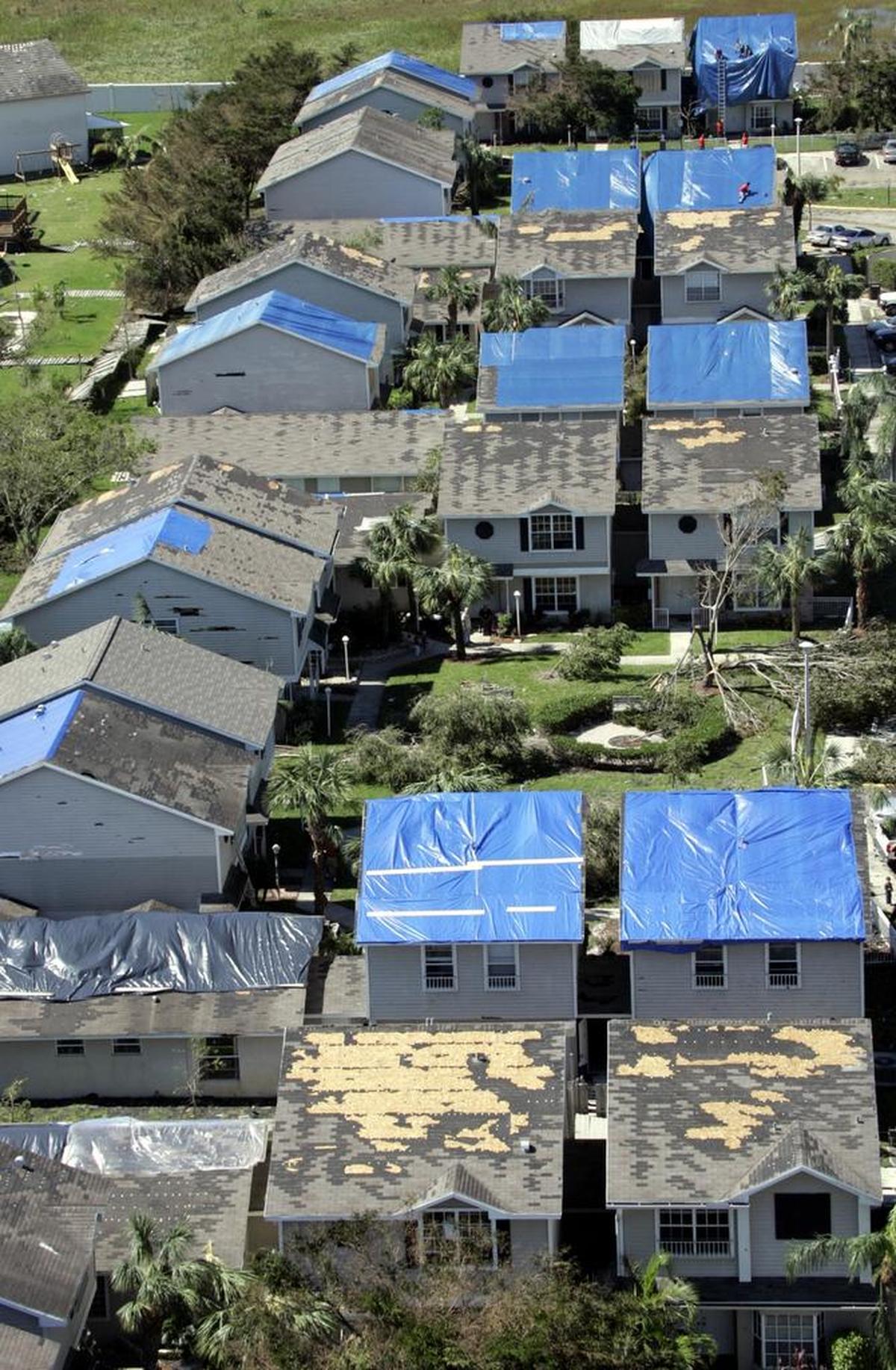 Homeowners covered their roofs in blue tarps to cover damage cause by Hurricane Wilma in Broward County in 2005. Widespread damage can cause insurers to go under or pull out of the state.