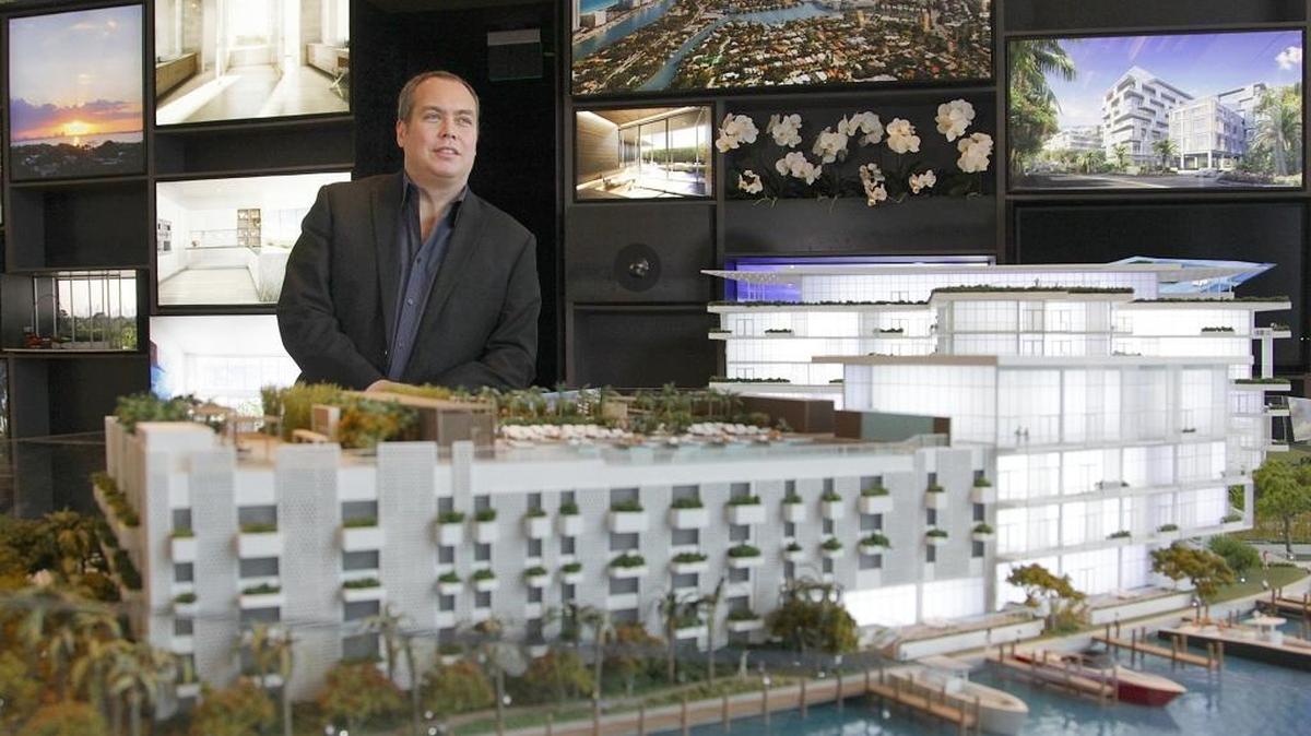 Jon Cardello, senior principal and architect at Stantec, stands next to a scale model of the Ritz-Carlton Residences Miami Beach, which his firm designed.