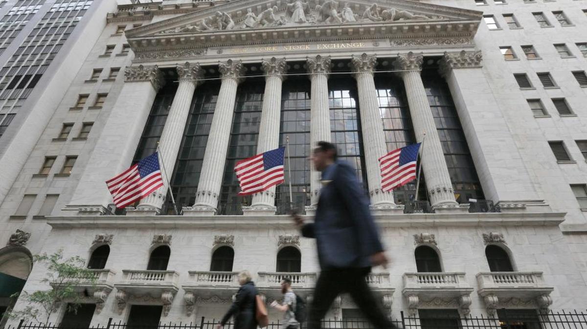 People walk by the New York Stock Exchange. “All in all, the common denominator in stock, real estate and bond market bubbles is this: Everyone is rushing to the fire exit, but they cannot get out in time,” says Jay Schechter of Singer Xenos Schechter Sosler Wealth Management, based in Coral Gables.
