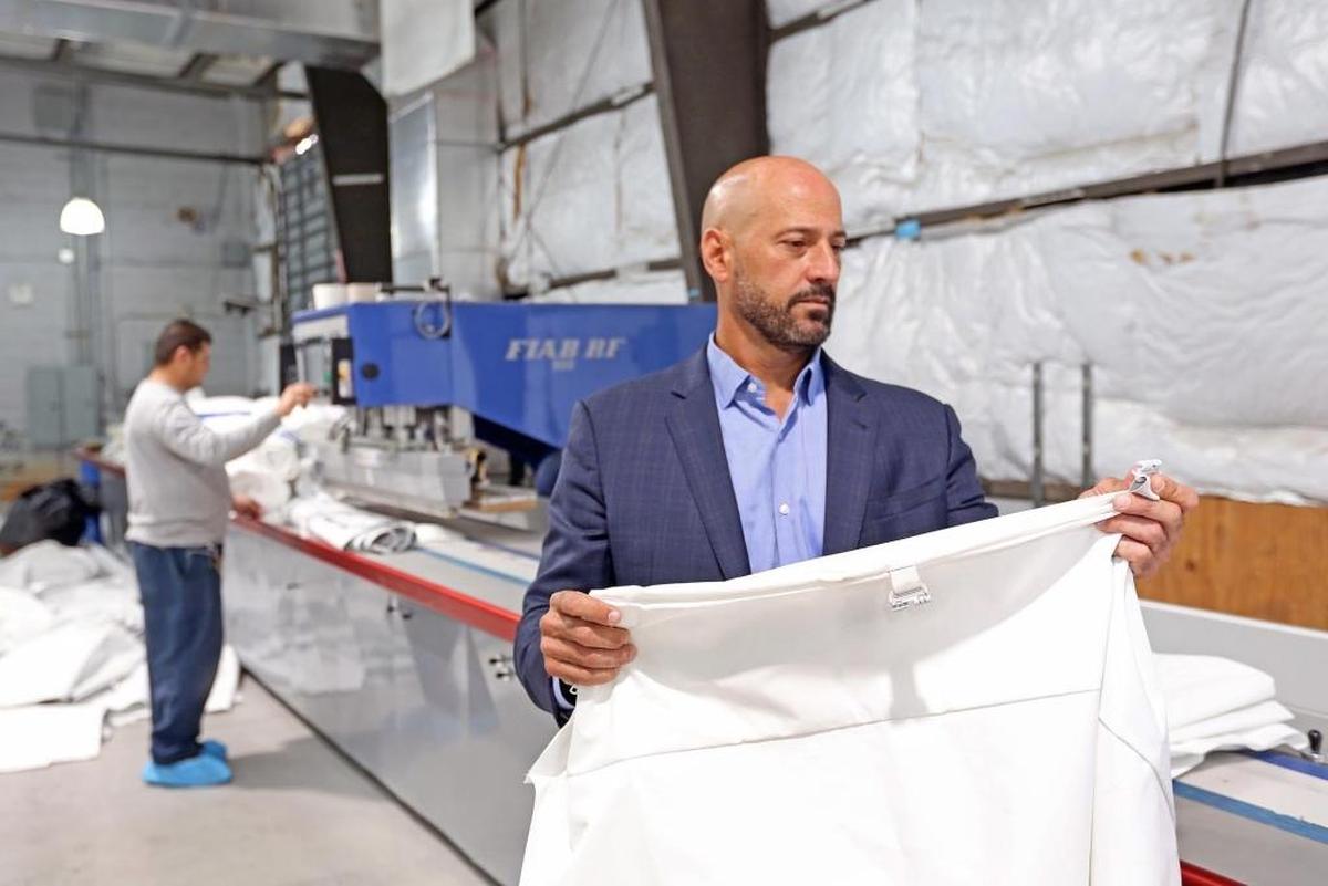 Alain Perez of Eventstar checks fabrics to make sure they have a proper seal.