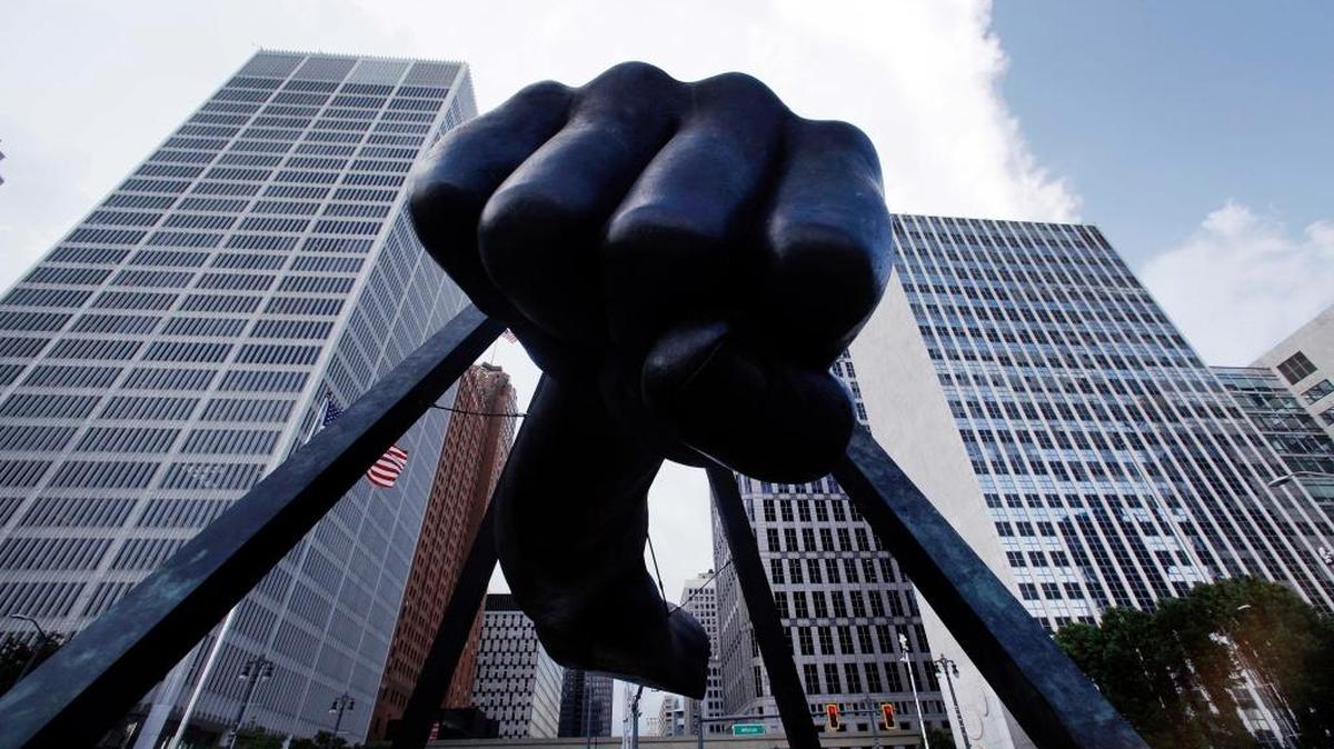 The Detroit skyline rises behind the Monument to Joe Louis, also known as "The Fist," Thursday, July 18, 2013.