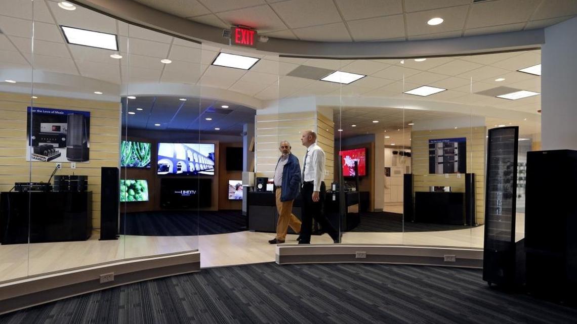 Vice President of Sales A.J. Stockton (right) walks with a customer at the Sound Advice store at 9131 S. Dixie Hwy.