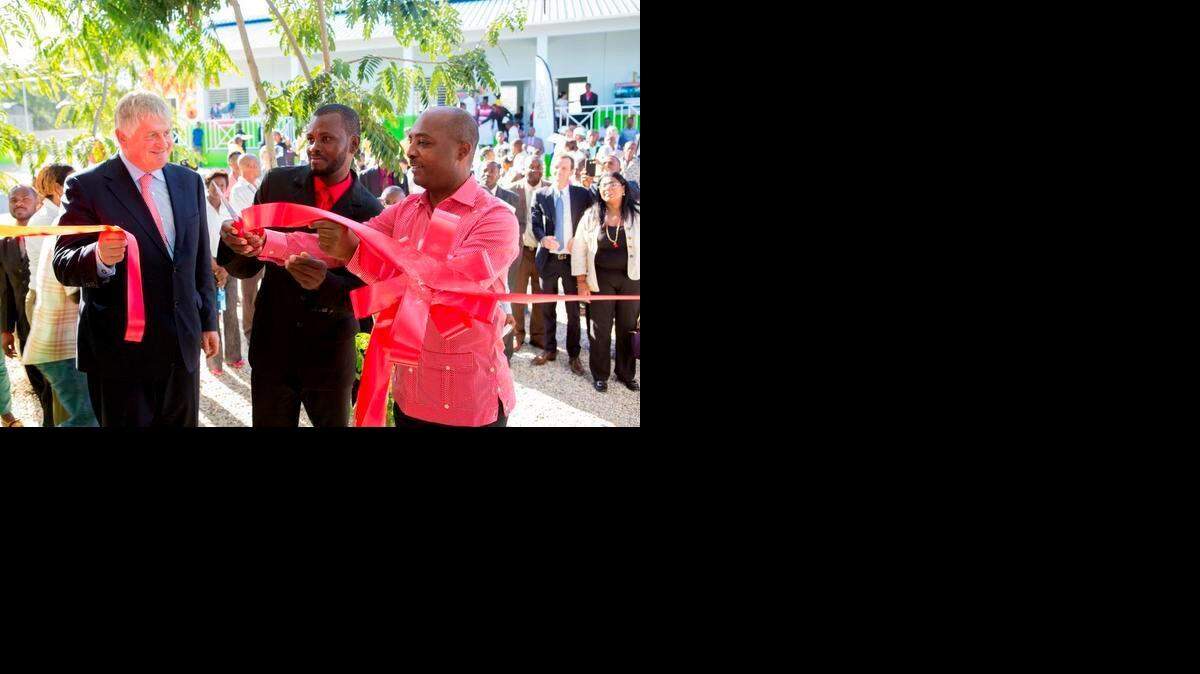 
Digicel Group founder and chairman Denis O’Brien (left), School Principal Isaac Césaire (center) and Haiti Minister of National Education and Vocational Training Nesmy Manigat (right) cut the ribbon in November on the 150th school the telecom company built in Haiti. The school is located on the northern outskirts of the capital near Saut d’eau.
