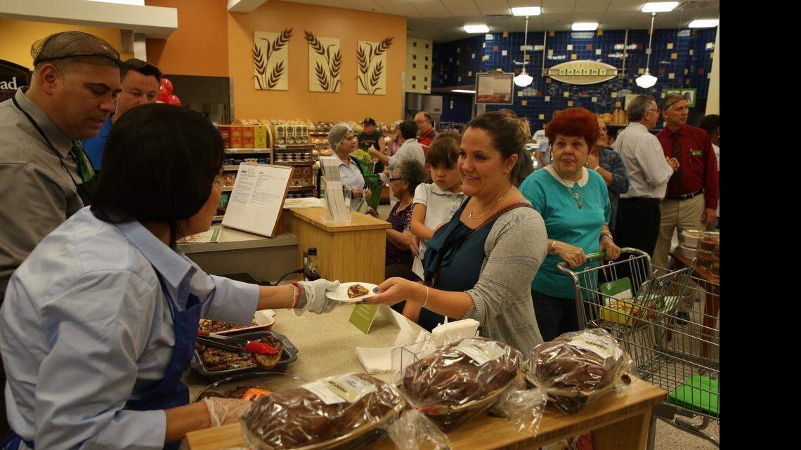 
Nicole Erdmann holds Arianna Ruz 3, sampling french toast at the newly remodeled Publix grand re-opening, at 9420 SW 56th Street in Miami on April 23.

