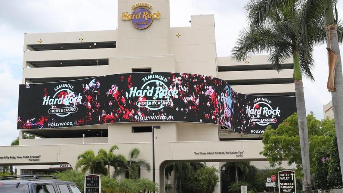 A large, digital screen welcomes guests to the Seminole Hard Rock Hotel & Casino near Hollywood. The hotel is one outpost of a global brand with 22 hotels and one racino, and entities in 68 countries between its hotels, cafes, casinos and concert venues.