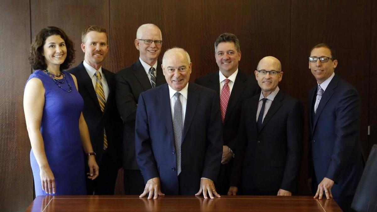 David Levine, 66, founding partner of Levine Kellogg Lehman Schneider & Grossman in Miami, center, is flanked by, from left: Stephanie Traband, Jason Kellogg, Lawrence Kellogg, Jeffrey Schneider, Thomas Lehman and Stuart Grossman. “We knew from previous experiences that unless we built our firm with a succession plan, in five or 10 years we would not survive,” Levine said.